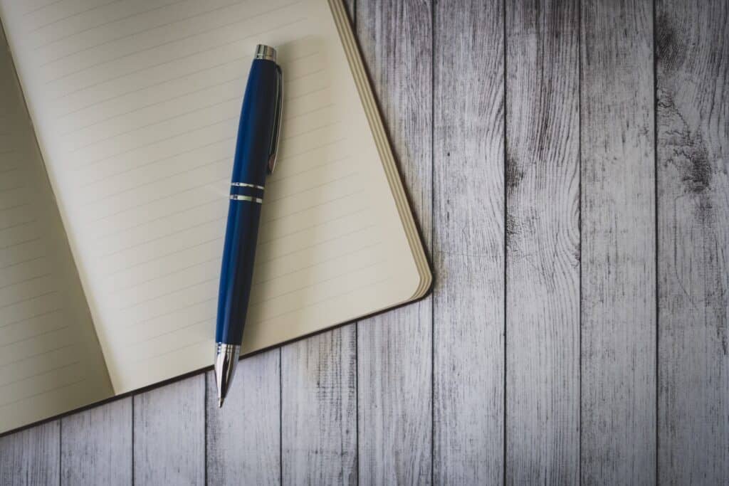 Ballpen on notebook for aspiring writers